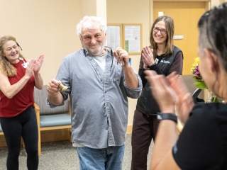 Medical professionals celebrate with a cancer survivor.