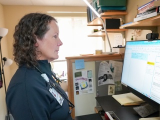 Emily Byrne, NP, reviews patient test results on a computer at Central Vermont Medical Center.