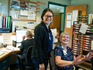 Staff at Woodridge pose together and smile at the camera.