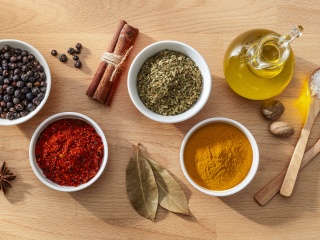 Small dishes of cooking spices and oil.