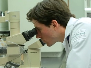 Resident looking in microscope