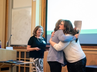Woman hugging nurse as she receives an award