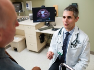 Candid portrait of Dr. Gerson speaking with patient.
