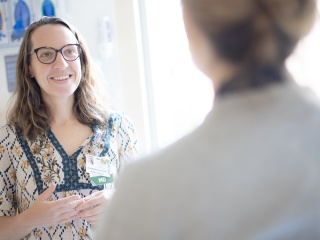 Dr. Fenton speaks with patient in exam room.