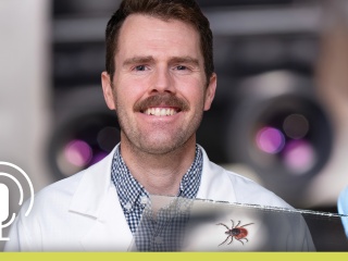 Portrait of Peter Hyson, MD overlaid with a tick on a slide in the bottom right and a microphone icon in the lower left.