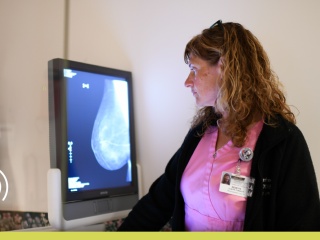 Radiology technician looking at a breast mammogram