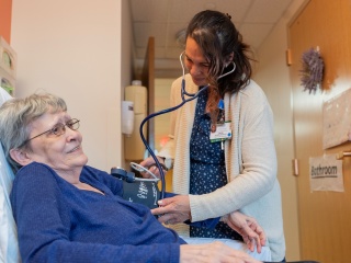 CVPH Skilled Nursing Facility (SNF) provider listens to patient heart beat.