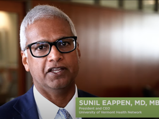 A YouTube still shows Sunil Eappen, MD, MBA, President and CEO of the UVM Health Network. 