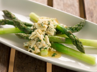 Asparagus mimosa salad sits on a plate.