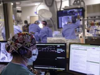 Nurse Jean Laird, RN, monitors a TAVR procedure to replace an aortic heart valve.