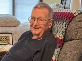 Ralph Page sits in his recliner at home.