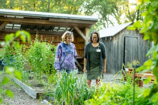 Garden Educator Rachel Boyers and a participant standing in garden at Fanny Allen Learning Garden Class.