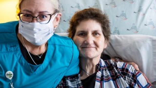 A Home Health and Hospice nurse smiles with a resident of the McClure Miller Respite House.