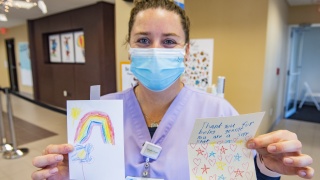 Vaccinator Melissa Brookman, RN, shows off cards kids made for her after she administered the first doses of the COVID-19 vaccine on the first day of the University of Vermont Children’s Hospital vaccine clinic for kids 5 to 11 years old in Williston on Wednesday, Nov. 10, 2021.