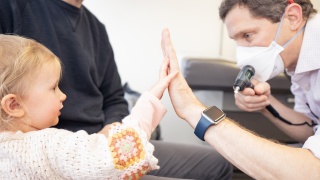 Pediatric patient high fives pediatrician. 