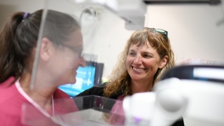 Robyn Thwaits, mammographer helps patient with mammogram