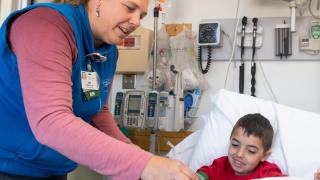 A medical provider plays with a pediatric inpatient. 