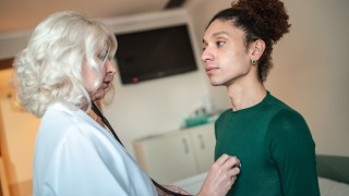 A medical provider checks the heartbeat of a patient.