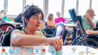 A resident plays a board game.