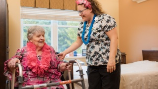 A nurse assists patient in a wheelchair.