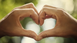 Two hands forming the shape of a heart.