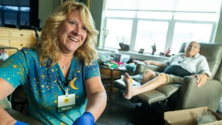 Home Health and Hospice nurse Julia Bleau cares for a patient during a home visit.