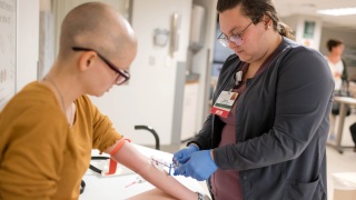 An Alice Hyde Medical Center nurse treats a patient in the Emergency Department.