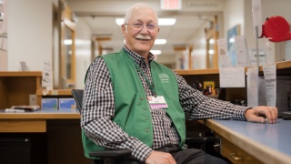 A Porter Medical Center volunteer sits at the greeting station.