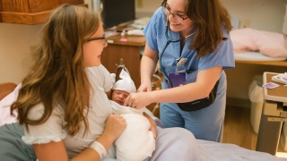 A nurse at Porter Medical Center listens to a baby's heart at the birthing center.