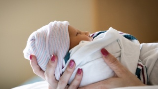 A baby is held by a mother at the University of Vermont Medical Center Birthing Center.