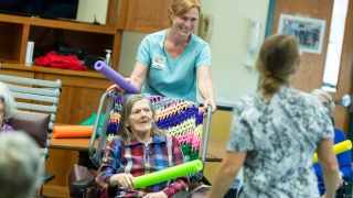 Staff and residents of Woodridge Rehabilitation and Nursing at Central Vermont Medical Center do an activity with pool tubes.