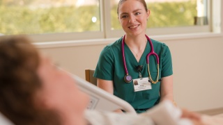 ECH LPN sitting with patient.