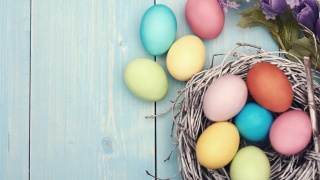 Painted easter eggs in a bird nest.