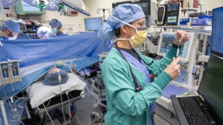 Anesthesiologist provides anesthesia to a patient during surgery.