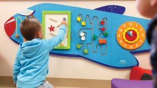 A child plays in the waiting area of Alice Hyde Medical Center Pediatrics.
