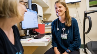 A University of Vermont Medical Center Cardiology Nurse Practitioner talks to a patient during an office check up.