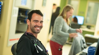 Nurses at University of Vermont Medical Center Miller 5 smile while working.