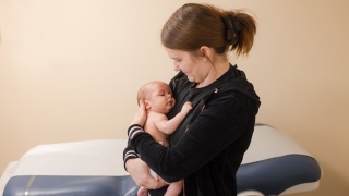 A mother cuddles her baby at a medical check up at Porter Medical Center.