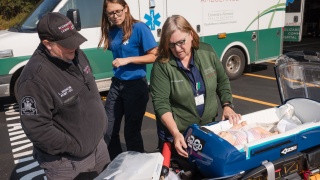 An Elizabethtown Community Hospital Paramedic and colleagues work on ambulance and infant simulation training.
