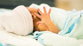 Infant swaddled in the NICU.
