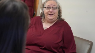 Patient Staci Ann Grove speaks with a nurse at UVM Medical Center.