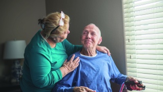 Two adults comfort each other.