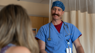 A medical professional speaks with a patient.