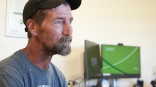 Aaron Blair sits in an office.