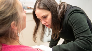 A dermatologist examines a patient's skin in an exam room at Central Vermont Medical Center..