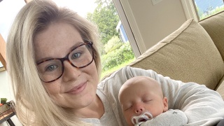 Sage Collins poses for a photo with her infant son. 