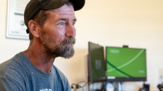 Patient Aaron Blair meets with addiction treatment counselors during an appointment for MOUD.