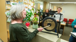 A person bangs the gong at the Cancer Center.