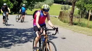 Dorsey Naylor rides her bike on a bike path.