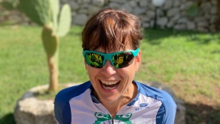 Portrait of Keele Kozak wearing biking clothing outside.